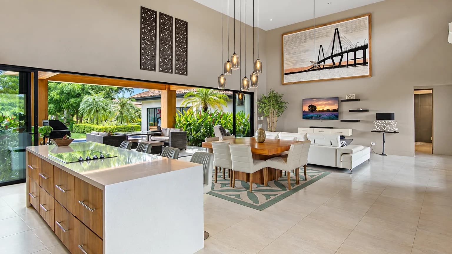 Open plan living, dining and kitchen under a high ceiling